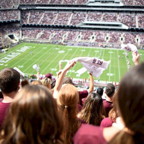 Aggie Fans waving gameday towels at a football game in Kyle Field
