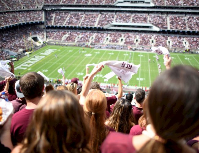 Aggie Fans waving gameday towels at a football game in Kyle Field