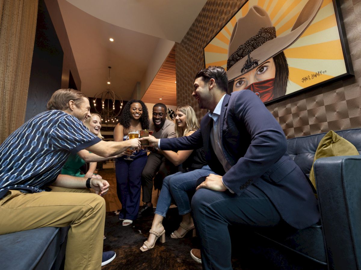 group of young adults toasting at The Rail bar