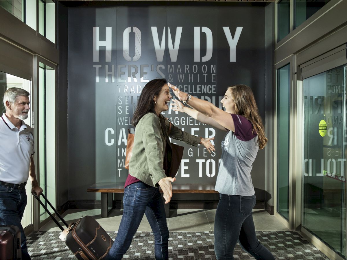 Family embracing in hotel lobby