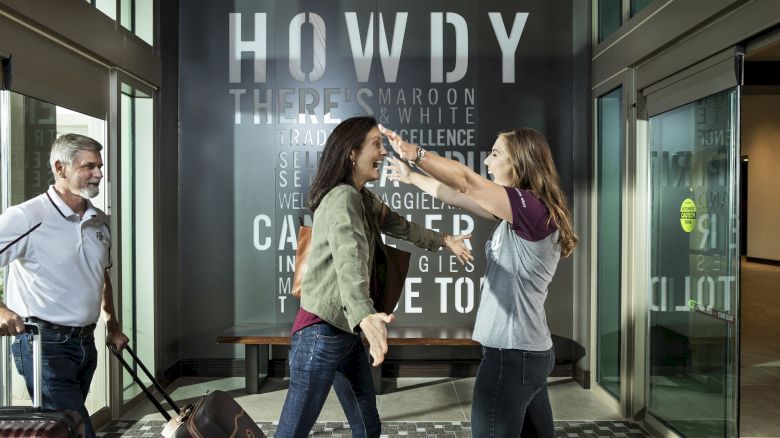 Family embracing in hotel lobby