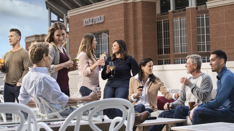 Friends drinking and having conversation on the Block T Bar Patio