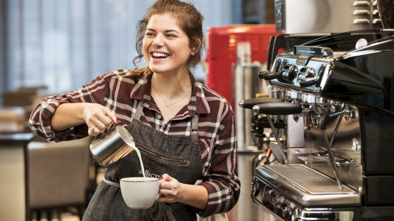 Barista pouring cream