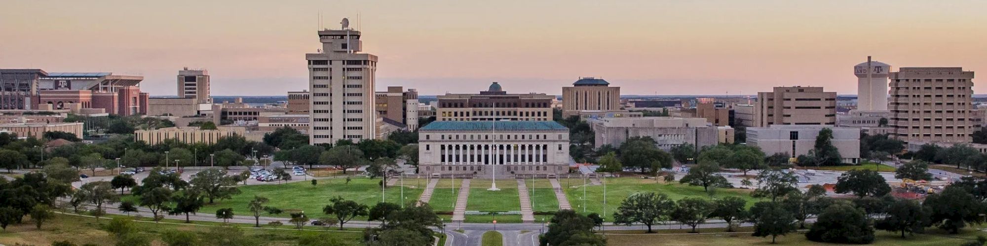 Panoramic view of Texas A&M Campus at sunset with admin building centered