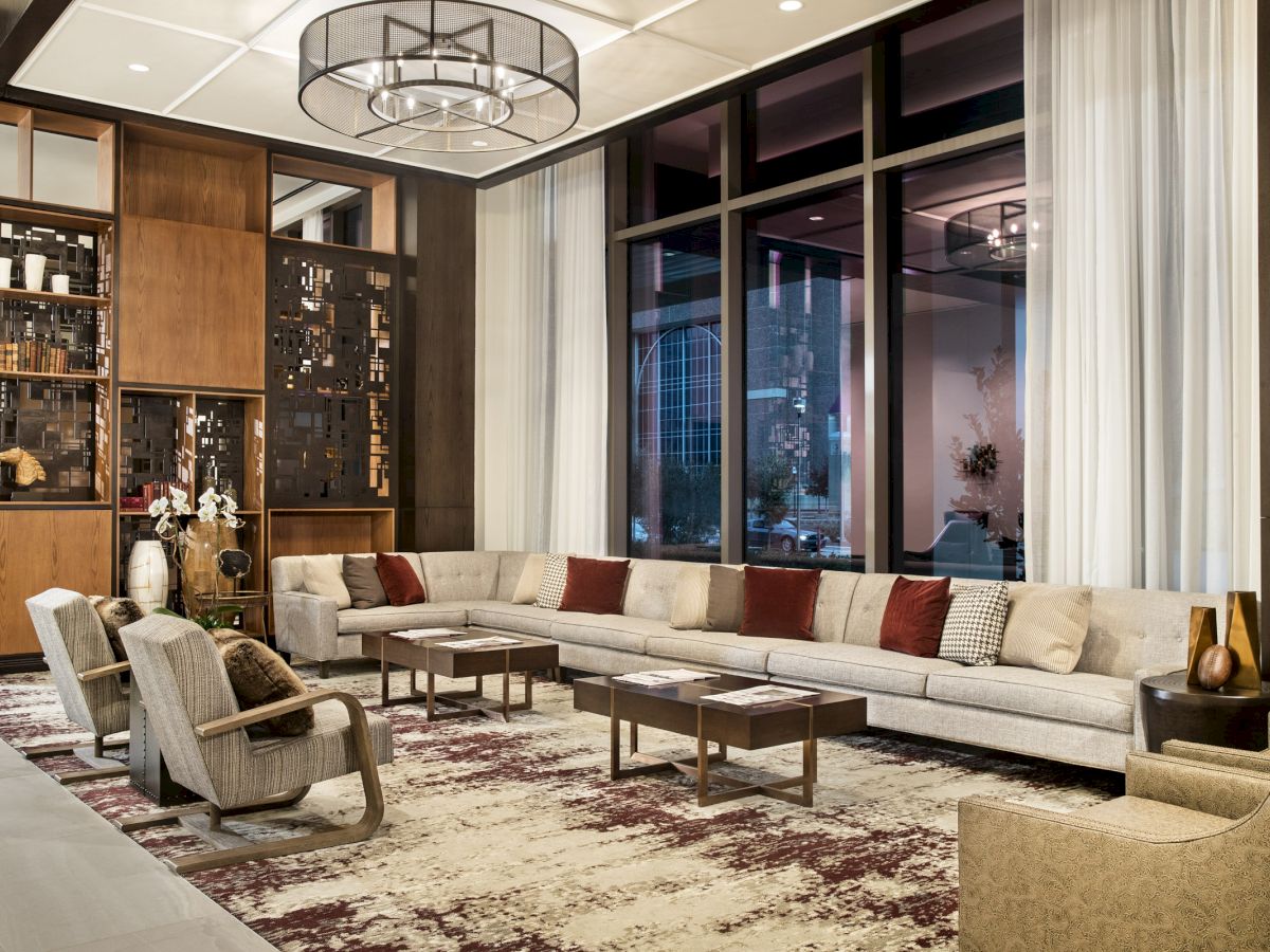 Hotel Lobby with a large grey couch in front of floor length windows