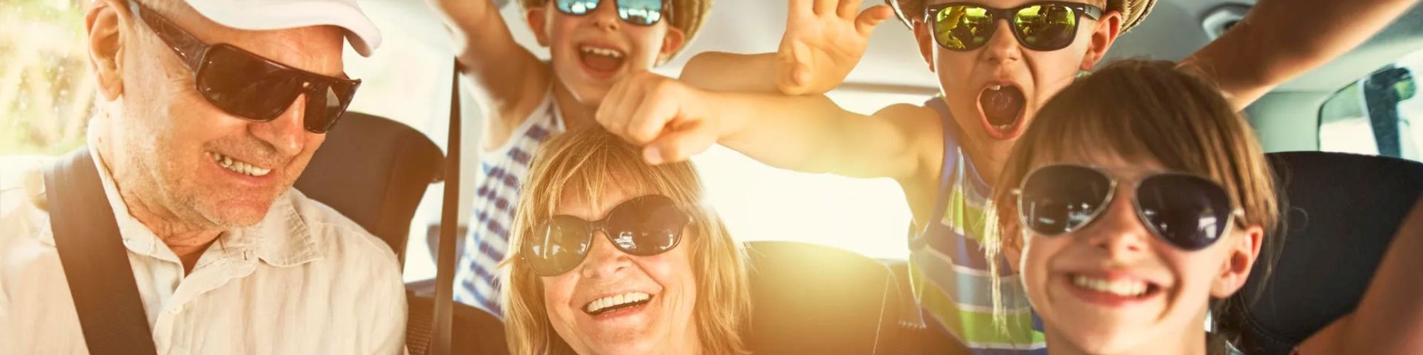 family in a car driving to vacation