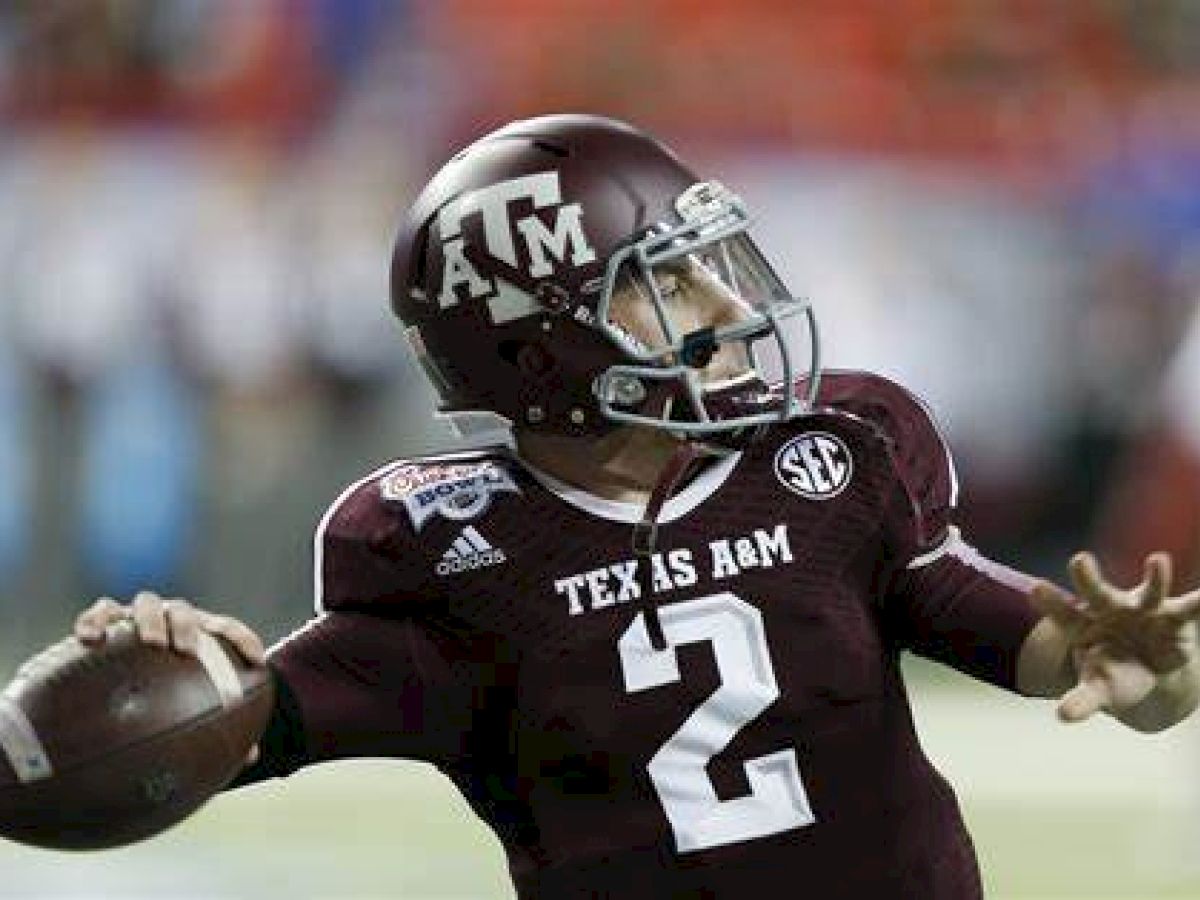 Aggie Football Player throwing a football