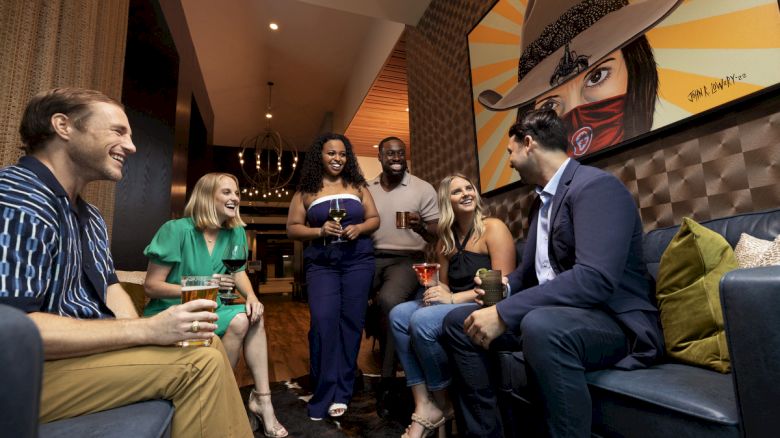 young adults enjoying pre-dinner drink at The Rail