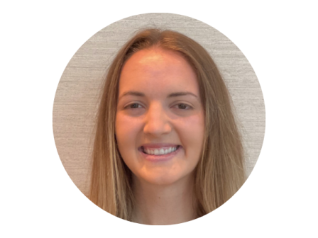 The image shows a person with long hair, smiling against a neutral background in a circular frame.