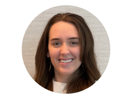 The image shows a person smiling, with long hair, against a neutral background, presented in a circular frame.